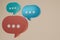 3D render orange,blue and green Minimal chat bubble. Contact us or chat icon 3D in beige background. Concept of communication,