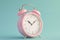3D render of pink alarm clock isolated on blue background