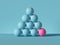 3d render, pyramid of balls isolated on blue background. Billiards game. Primitive geometric shapes. One of a kind metaphor.