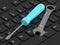 3d render of screwdriver with wrench lying on computer keyboard