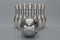 3d render silver bowling ball crashing into the pins on light gray background. Concept of success and win. 3D rendering