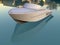 3D render - small yacht reflecting in water near buildings