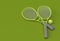3D Render Sport equipment tennis racket with a ball on green Background