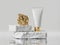 3d render. White cream tube with golden cap placed on rough cobblestone platform. Abstract skin care product, luxury cosmetics.