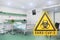 3d render of a yellow warning sign for biological hazards and the message SARS-CoV-2 in a hospital