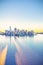 3D rendered illustration of futuristic New York City skyline with reflection at dawn