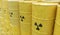 3D rendered illustration of many radioactive barrels. Nuclear waste dumping concept