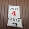 3D rendered illustration of realistic wall calendar turning to 4th of july previous sheet falling down