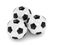 3d rendered three soccer balls isolated over white