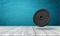 3d rendering of 25 kg weight plate on white wooden floor and dark turquoise background