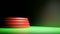 3D rendering. 3D illustration. A rounded red podium on a green floor being illuminated by a spotlight from the right.