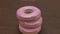 3D rendering of 5 donuts falling and stacking with camera moves in slow motion