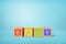 3d rendering of alphabet toy blocks on blue background.