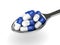 3d rendering of antibiotic pills in spoon isolated over white