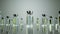 3D rendering of an array of small vials of a vaccine against a solid gray background