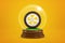 3d rendering of automobile wheel inside glass ball globe on amber background.
