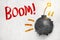 3d rendering of ball bomb with fuse breaking white wall with `Boom` sign on white background