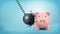 3d rendering of a black swinging wrecking ball breaks itself when collides with a large piggy bank.