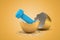 3d rendering of blue dumbbell hatching out of golden egg on yellow background