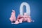 3d rendering of broken pink piggy bank with stone `0` number inside on blue background.