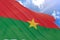 3D rendering of Burkina Faso flag waving on blue sky