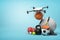 3d rendering of camera drone putting basketball in pile of sports equipment on light blue background with copy space.