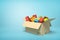 3d rendering of cardboard box full of colorful toy bricks on light-blue background with copy space.