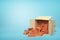 3d rendering of cardboard box lying sidelong full of new brown perforated bricks on blue background.