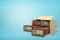3d rendering of cardboard box lying sidelong full of old-fashioned radios on light-blue background.