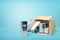 3d rendering of cardboard box lying sidelong with several ATMs inside and some outside on light-blue background with