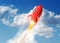3D rendering of cartoon funny red rocket launching in the clouds