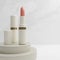 3D rendering closeup lipstick on podium with marble background