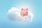 3d rendering of a cute pink piggy bank on a fluffy white cloud in the blue sky.