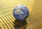 A 3D rendering of the earth sit on row of 1000 gram  fine goldbar