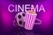 3d rendering of film reel and striped popcorn bucket with title `CINEMA` behind on gradient purple background.