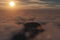 3D rendering from a flight over a cloudy mountain scenery at sunrise