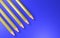 3d rendering four yellow pencils on a blue background