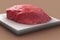 3D rendering of a fresh raw piece of beef on a white plate