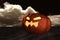 3D rendering : Halloween head jack-o-lantern pumpkin in a mystic dessert at night with sky and cloud in background.halloween
