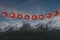 3d rendering of hanging lighten lantern covered with swiss flag over mountain pasture with view to the alps