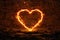 3d rendering of heart frame on fire over rocky surface