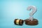 3d rendering of hefty stone question mark standing on sounding block with gavel beside on light-blue background with