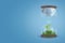 3d rendering of an hourglass with thick clouds in its upper half and a green sprout in the lower half on a light-blue