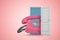 3d rendering of huge pink retro landline phone emerging from open door on pink gradient copyspace background.