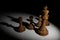 3D Rendering : illustration of chess pieces.the wooden king chess at the center with pawn chess in the back.light drop to chess