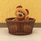 3D rendering illustration of a cute brown toy bear sitting in a wicker basket