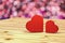 3D rendering : illustration of valentines day conceptual,two heart put on wooden table with out of focus light in background