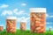 3d rendering of medical jars of pills on green grass and blue sky background