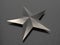 3D rendering - metallic star on carbon fiber