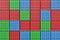 3d rendering of multiple red, blue and green closed shipping containers stacked on one another.